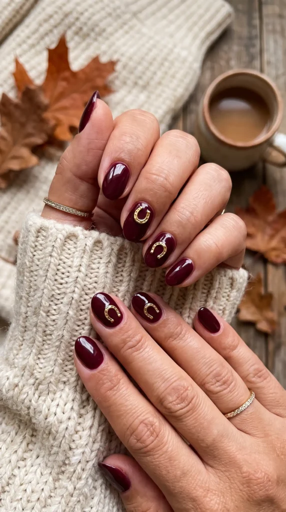 Add Some Luck with Horseshoe CharmsChannel your inner cowgirl with lucky horseshoe motifs. This is one of the easiest ways to incorporate western style into your fall manicure without going overboard. The contrast between a metallic gold horseshoe and a deep, moody base color is absolutely stunning.Paint your nails in a rich burgundy or deep navy blue. Then, add gold horseshoe decals or hand-paint them on one or two accent nails. For an extra dose of luck, position some of the horseshoes upside down.
